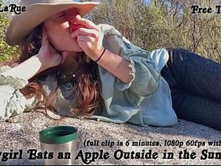&quot_Cowgirl Eats an Apple Outside in the Sunlight&quot_